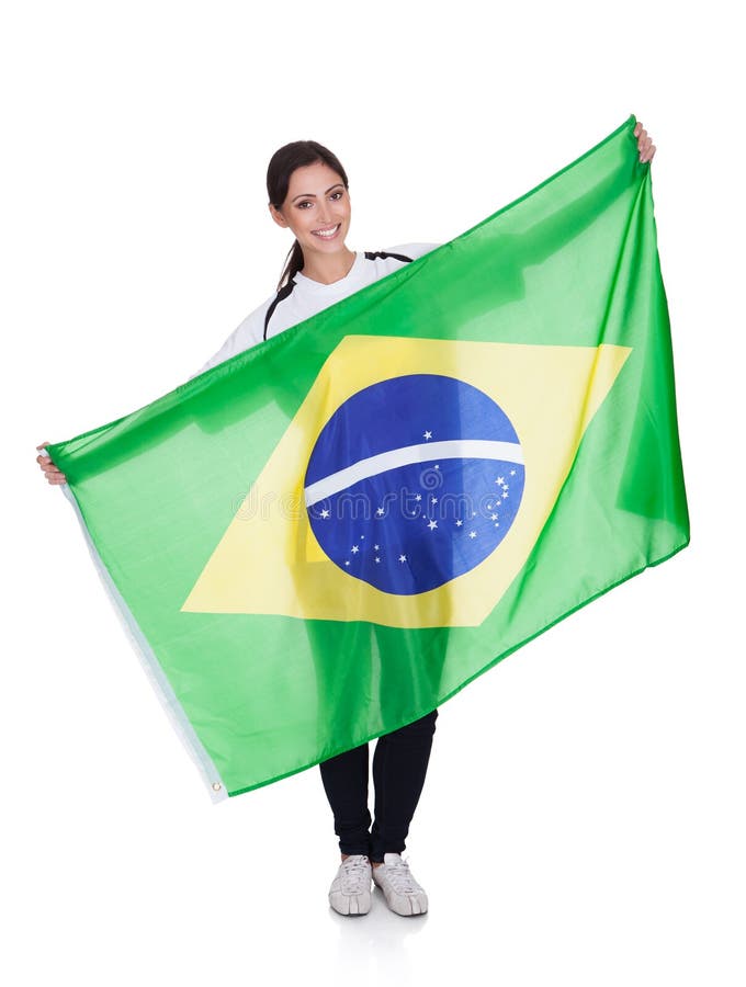 Femeie frumoasă care deține steagul brazilian royalty free stock photos