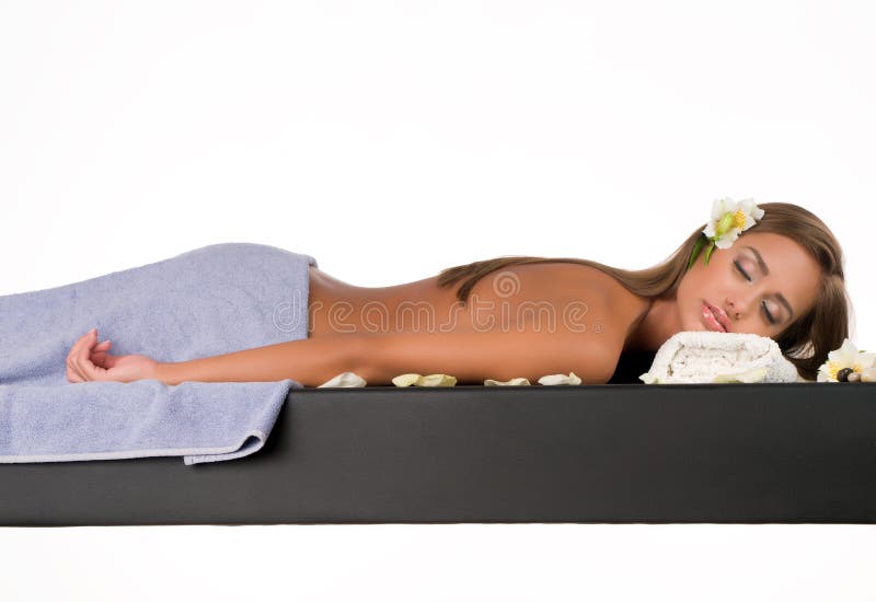 Beautiful young woman having a massage in a spa. Beautiful young woman having a massage in a spa