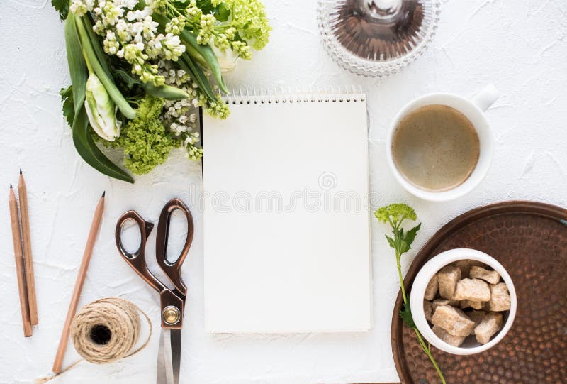 Feminine flatlay with flowers and ccoffee