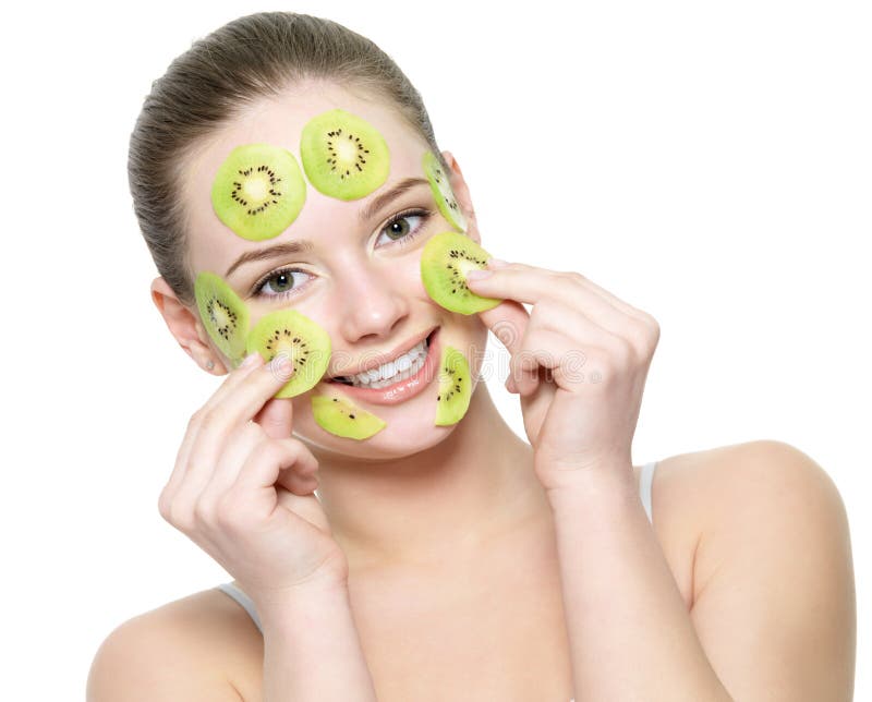 Happy young beautiful woman with a fruit kiwi mask on a face - isolated on white background. Happy young beautiful woman with a fruit kiwi mask on a face - isolated on white background