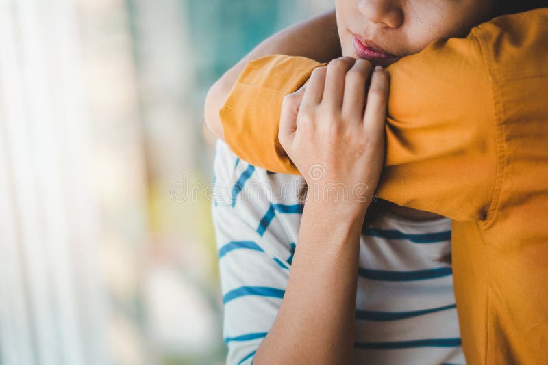 Young depressed asian women hug her friend for encouragement, Selective focus, PTSD Mental health concept. Young depressed asian women hug her friend for encouragement, Selective focus, PTSD Mental health concept.