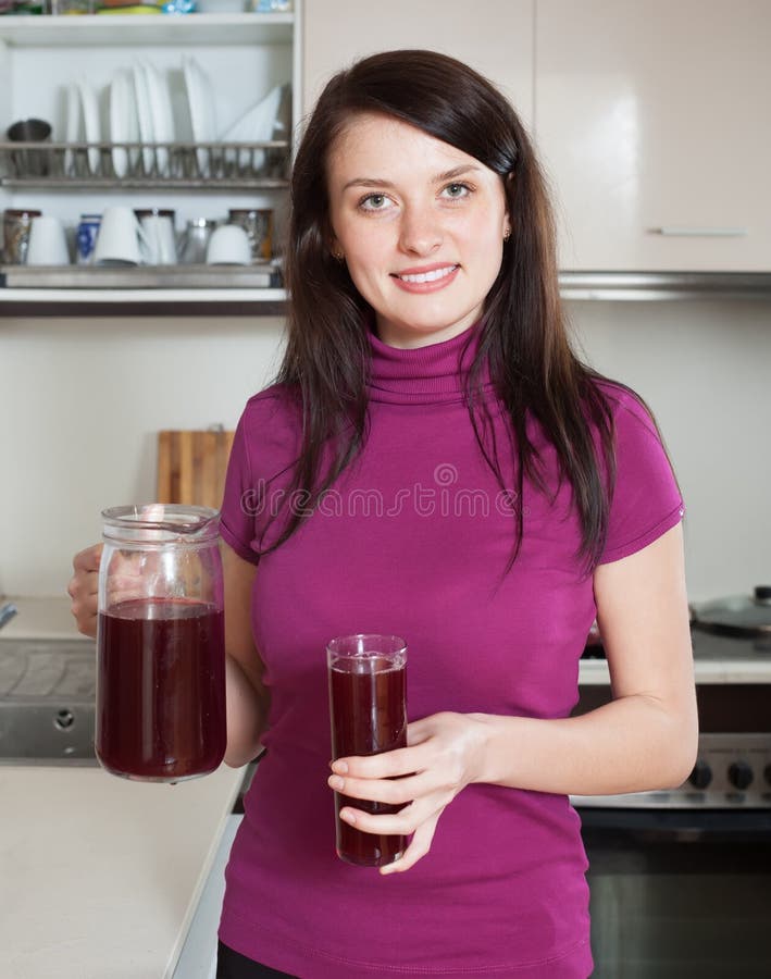 Femme avec la cruche de fruit-boisson ou de jus rouge photographie stock Femme avec la cruche de fruit-boisson ou de jus rouge photographie stock
