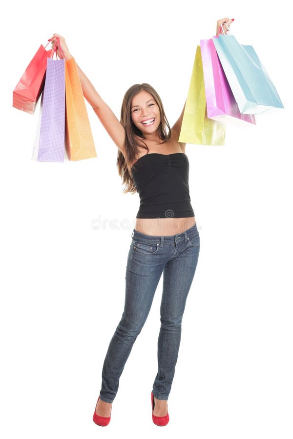 Shopping woman isolated happy holding shopping bags up in joy. Studio portrait of Asian / Caucasian shopper standing in full length isolated on white background. Shopping woman isolated happy holding shopping bags up in joy. Studio portrait of Asian / Caucasian shopper standing in full length isolated on white background.