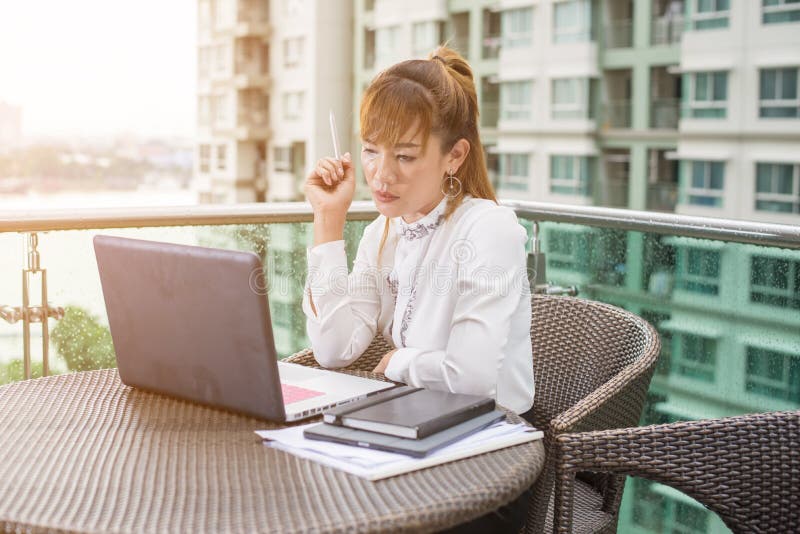 Femme d'affaires asiatique supérieure travaillant dans le bureau moderne image libre de droits Femme d'affaires asiatique supérieure travaillant dans le bureau moderne image libre de droits