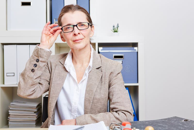 Femme d'affaires au bureau avec des lunettes photographie stock
