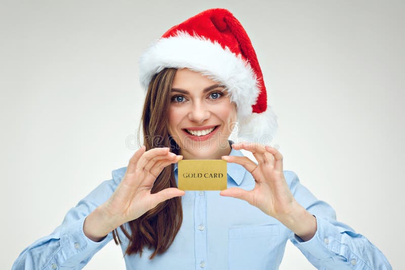 Femme d'affaires de Santa Girl tenant la carte de crédit d'or photos stock Femme d'affaires de Santa Girl tenant la carte de crédit d'or photos stock