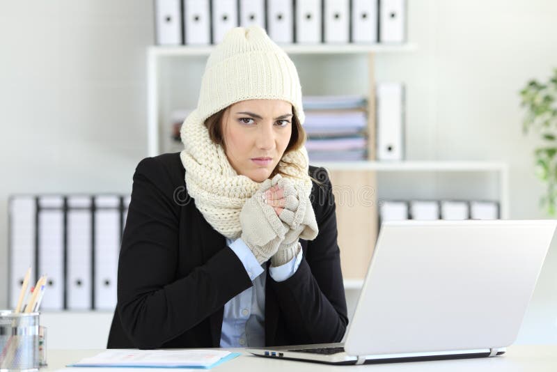 Femme d'affaires fâchée ayant le froid au bureau