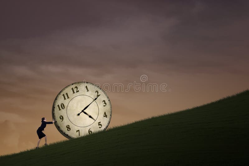 Businesswoman is pushing a big clock outdoor on top of a hill. Businesswoman is pushing a big clock outdoor on top of a hill