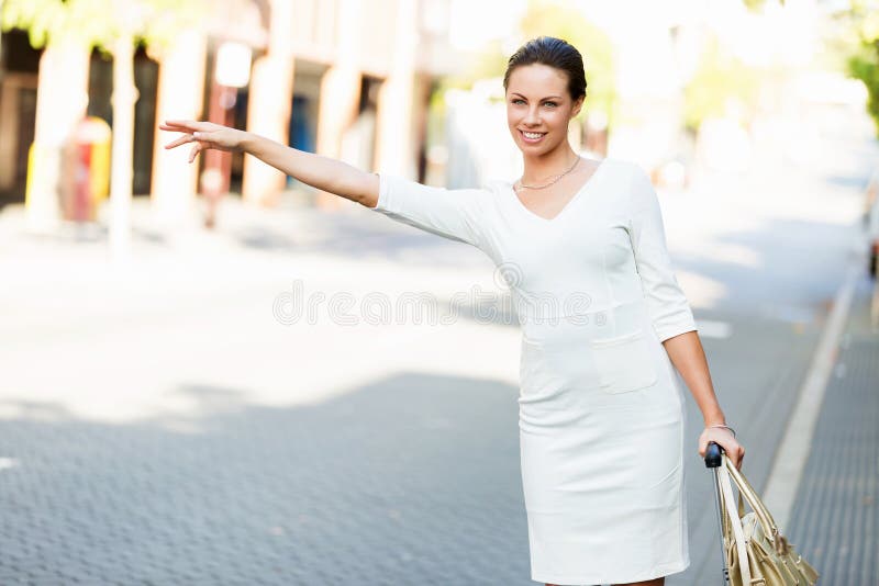 Femme d'affaires tirant le sac de valise marchant dans la ville
