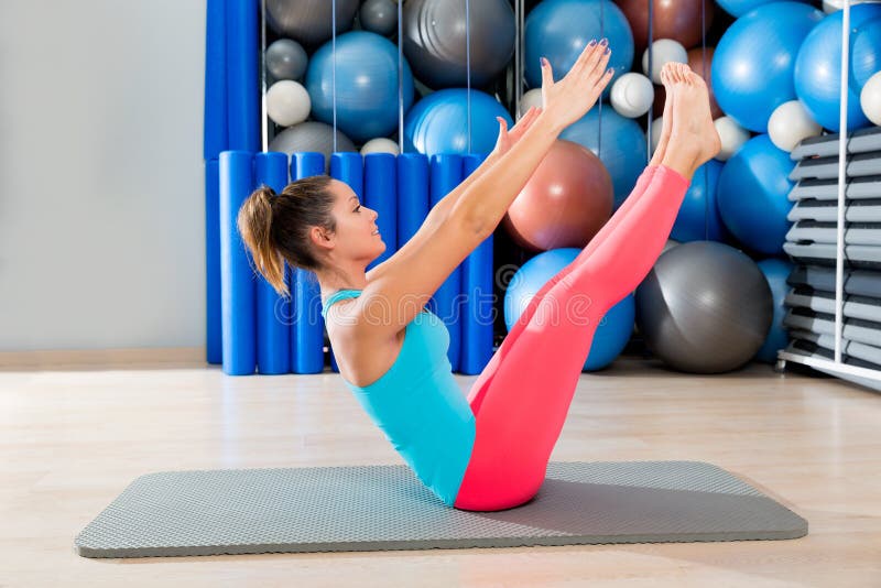 Femme d'exercice d'énigme de Pilates sur le gymnase de tapis d'intérieur image libre de droits Femme d'exercice d'énigme de Pilates sur le gymnase de tapis d'intérieur image libre de droits