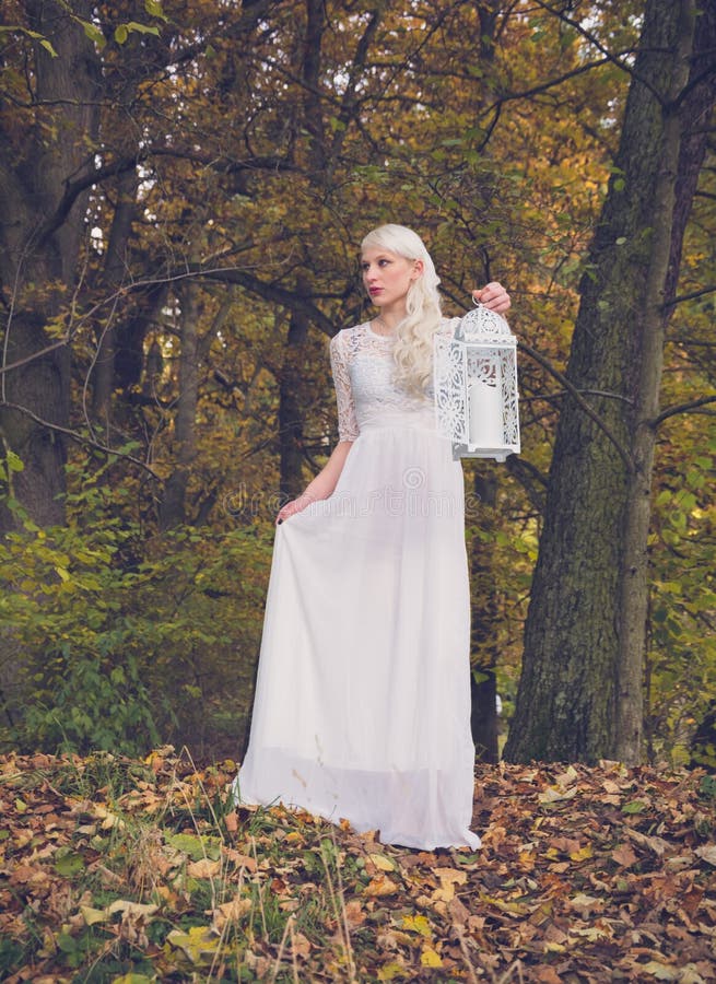 Femme dans la robe blanche et une lanterne photographie stock Femme dans la robe blanche et une lanterne photographie stock