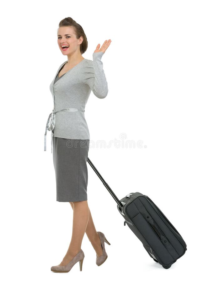 Femme de déplacement heureux avec la main de ondulation de valise photos libres de droits Femme de déplacement heureux avec la main de ondulation de valise photos libres de droits