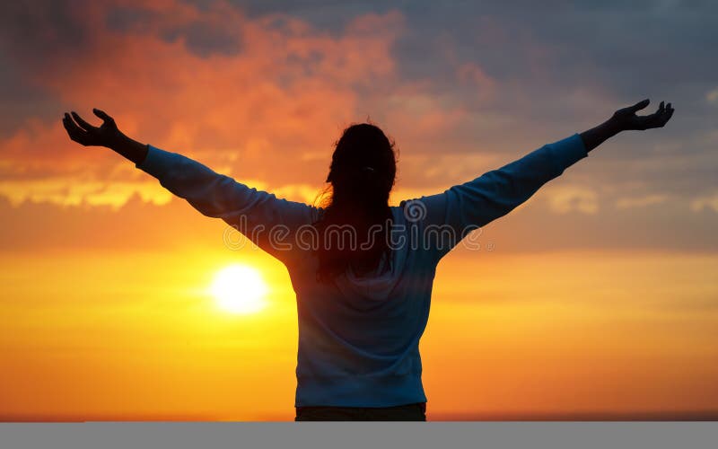 Free woman raising arms to golden sunset summer sky and ocean like praising. Freedom, success and hope concept. Girl relaxing and enjoying peace and serenity on beautiful nature. Free woman raising arms to golden sunset summer sky and ocean like praising. Freedom, success and hope concept. Girl relaxing and enjoying peace and serenity on beautiful nature.