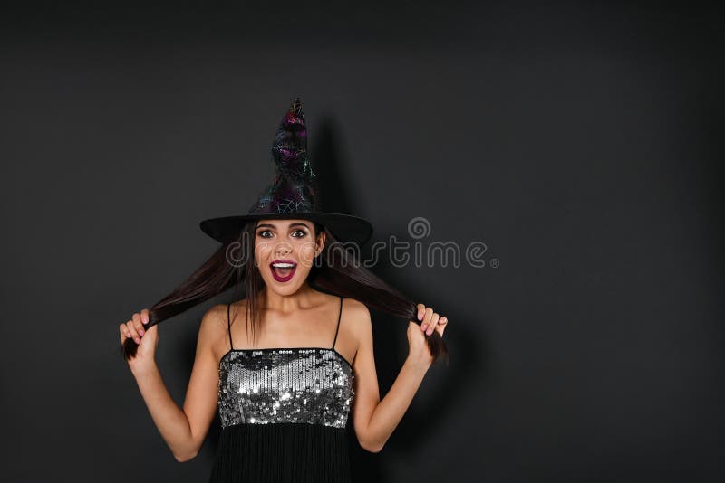 Excited woman wearing witch costume for Halloween party on black background, space for text. Excited woman wearing witch costume for Halloween party on black background, space for text