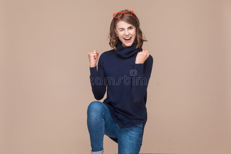 Femme expressive réussie se réjouissant sa victoire photographie stock libre de droits Femme expressive réussie se réjouissant sa victoire photographie stock libre de droits