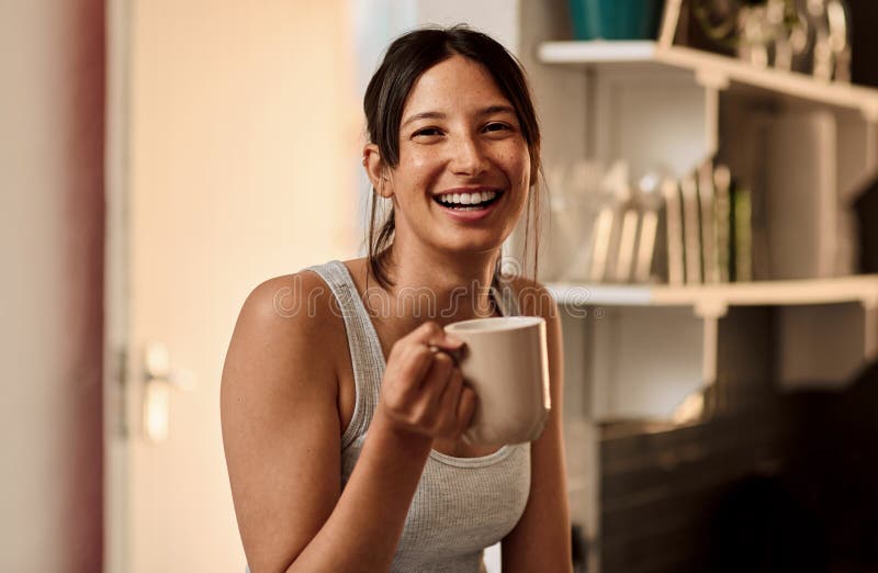 Woman, happy and coffee in kitchen at house for portrait with smile for caffeine as breakfast. Female person, beverage and playful, fresh and morning fix to feel energy, relaxed and refreshed. Woman, happy and coffee in kitchen at house for portrait with smile for caffeine as breakfast. Female person, beverage and playful, fresh and morning fix to feel energy, relaxed and refreshed.