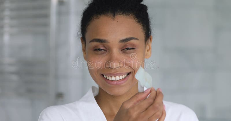 Femme heureuse afro-américaine utilisant la bande de nettoyage de nez.