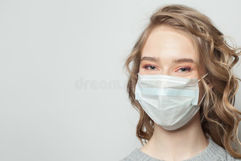 Happy woman in face mask on white background, female face close up. Happy woman in face mask on white background, female face close up.