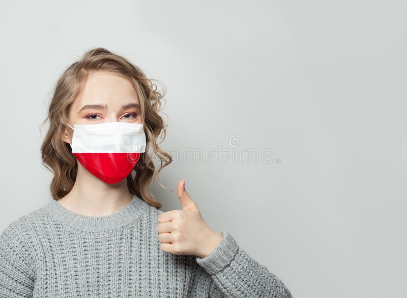 Happy woman in face mask holding thumb up with Poland  flag background. Flu epidemic and virus protection concept. Happy woman in face mask holding thumb up with Poland  flag background. Flu epidemic and virus protection concept.