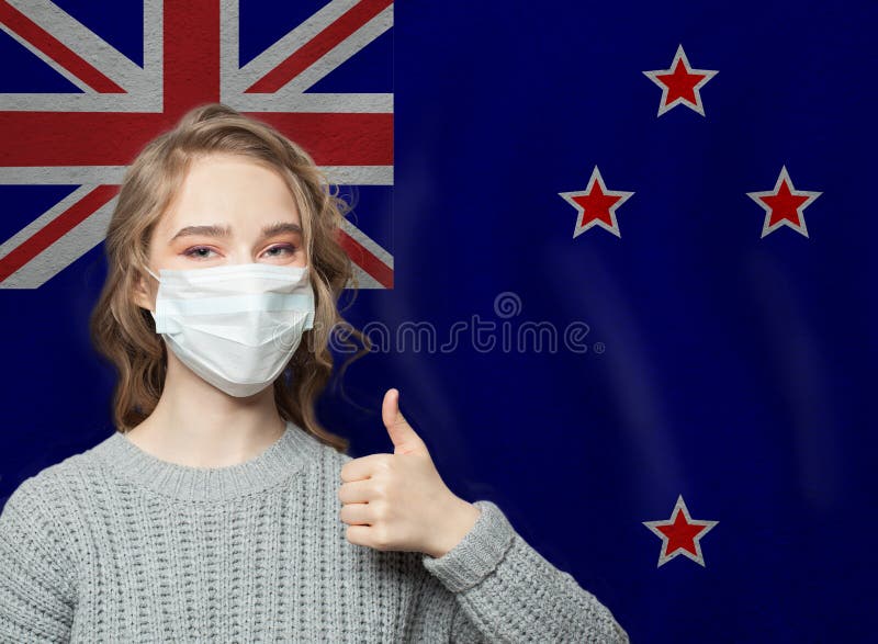 Happy woman in face mask holding thumb up on New Zealand flag background. Flu epidemic and virus protection concept. Happy woman in face mask holding thumb up on New Zealand flag background. Flu epidemic and virus protection concept.