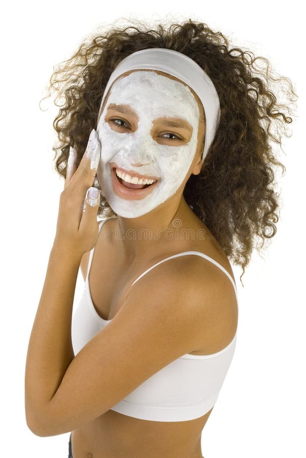 Young happy woman with white purifying mask. She's looking at camera. She's isolated on white background. Young happy woman with white purifying mask. She's looking at camera. She's isolated on white background.