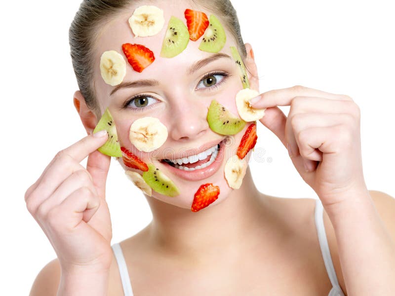 Portrait of happy cheerful young beautiful woman with fruit facial mask - isolated on white. Portrait of happy cheerful young beautiful woman with fruit facial mask - isolated on white