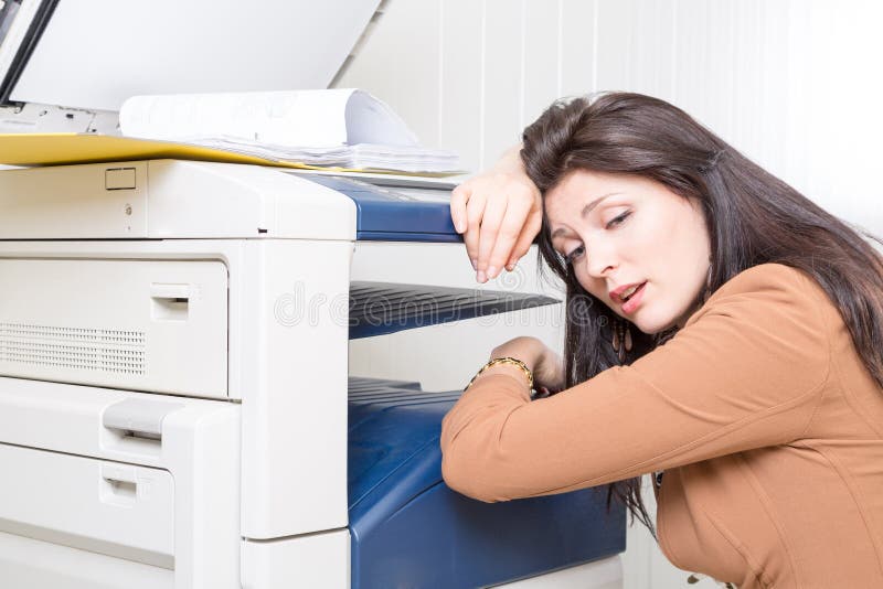 Pretty woman in office near the copier with documents. Pretty woman in office near the copier with documents