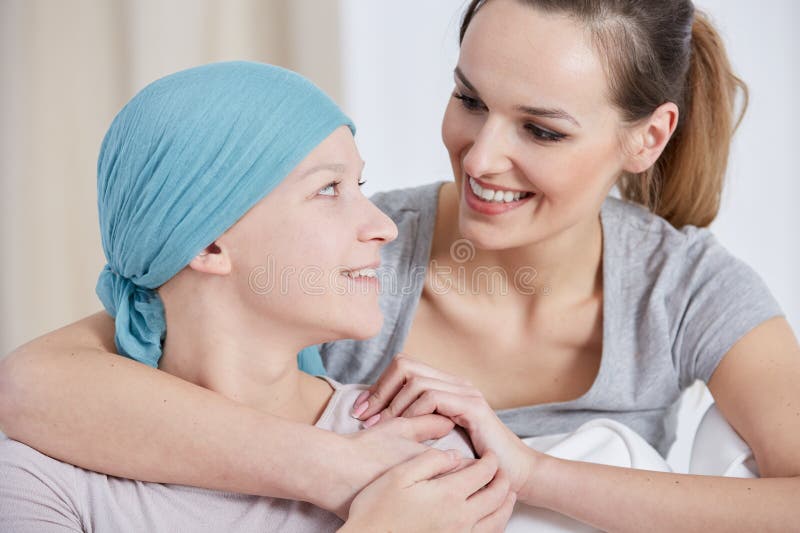Hopeful cancer women wearing headscarf, talking with friend. Hopeful cancer women wearing headscarf, talking with friend