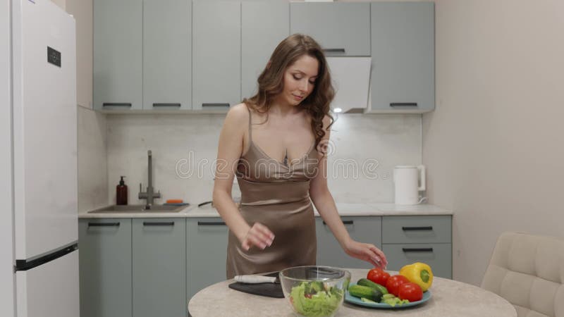 Femme préparant la salade dans la cuisine moderne banque de vidéos