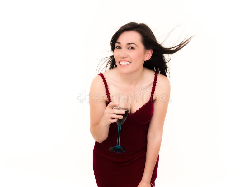 Femme retenant une glace de vin et de sourire image stock Femme retenant une glace de vin et de sourire image stock