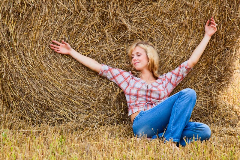 Femme s'étendant sur une paille photo stock Femme s'étendant sur une paille photo stock