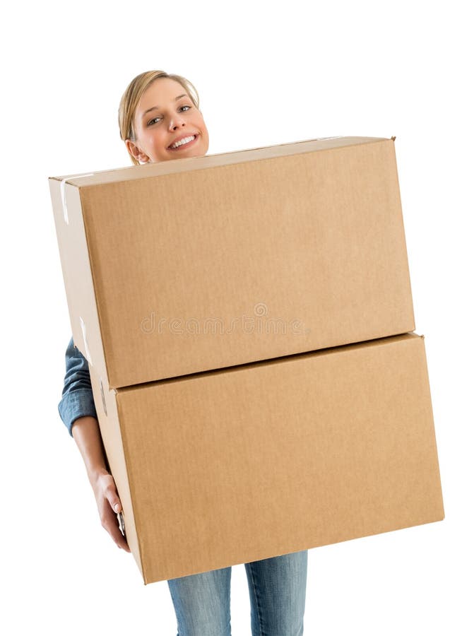 Femme souriant tout en portant les boîtes en carton empilées image libre de droits Femme souriant tout en portant les boîtes en carton empilées image libre de droits