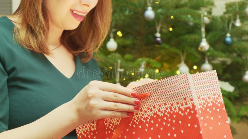 Femme Souriante Ouvrant Un Paquet Avec Un Cadeau à Une Fête De Noël Clips  Vidéos - Vidéo du collecte, fête: 262748007