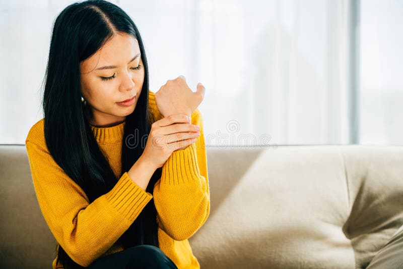 A woman experiencing wrist pain or Carpal Tunnel Syndrome holds her achy joint. Depicting discomfort inflammation and symptoms in the hand& x27;s anatomy. Health care concept. A woman experiencing wrist pain or Carpal Tunnel Syndrome holds her achy joint. Depicting discomfort inflammation and symptoms in the hand& x27;s anatomy. Health care concept