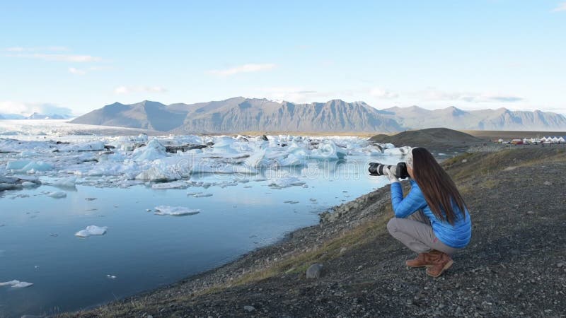 Femme touristique de photographe et prend des photos avec la caméra de appareil sur le voyage sur l'Islande