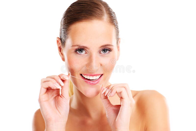 Femme utilisant la soie dentaire images libres de droits Femme utilisant la soie dentaire images libres de droits