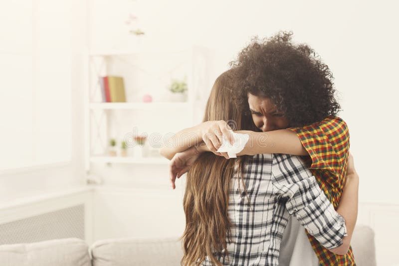 Woman hugging her depressed friend at home, closeup. Young girl supporting her crying girlfriend. Friendship consoling and care, copy space. Woman hugging her depressed friend at home, closeup. Young girl supporting her crying girlfriend. Friendship consoling and care, copy space