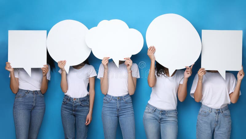 Women Holding Blank Speech Bubbles In Front Of Heads Expressing Their Opinion Over Blue Studio Background. Female Thoughts Concept. Women Holding Blank Speech Bubbles In Front Of Heads Expressing Their Opinion Over Blue Studio Background. Female Thoughts Concept