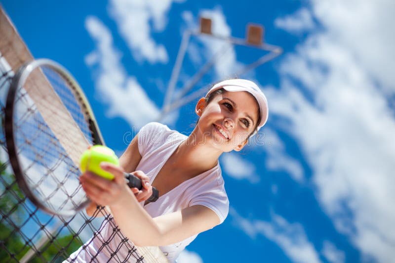 Female playing tennis on court. Female playing tennis on court