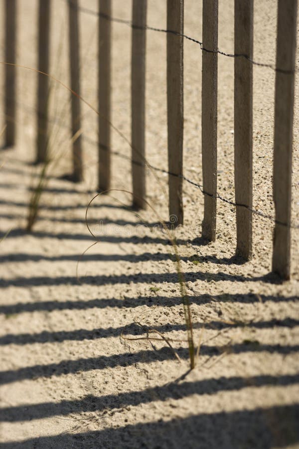 Fence on Bald Head Island, North Carolina. Close-up of fence and shadows on beach on Bald Head Island, North Carolina stock photos Fence on Bald Head Island, North Carolina. Close-up of fence and shadows on beach on Bald Head Island, North Carolina stock photos