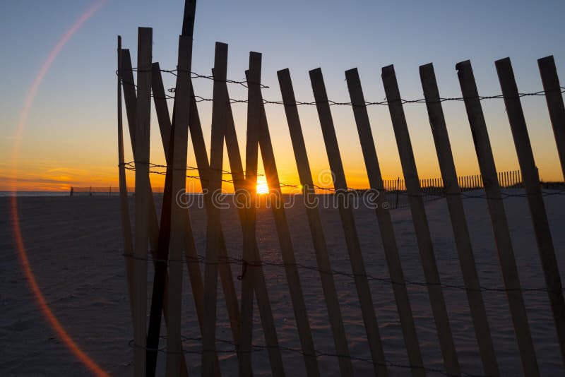 Fence on Beach during Sunset. Stock Image Image of sunset, flare