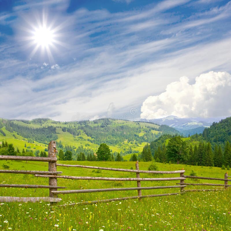 Fence in mountains meadow royalty free stock photos