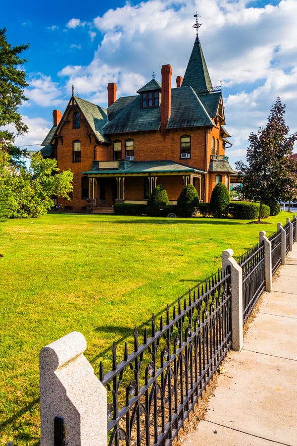 Fence and Old House in Spring Grove, Pennsylvania. Stock Photo Image