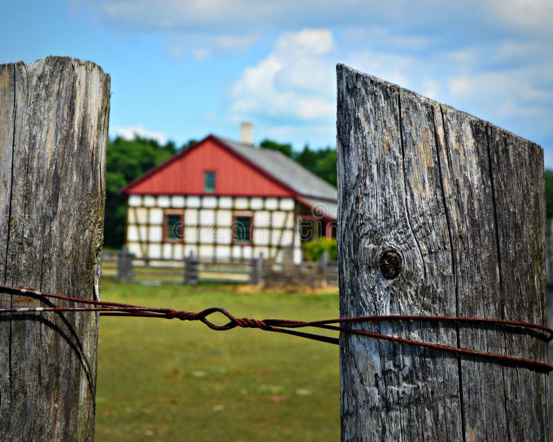 Fence Posts with Historic Building at Old World Wisconsin stock image Fence Posts with Historic Building at Old World Wisconsin stock image