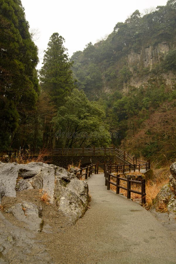 Fenced paved path into forest of Takachiho gorge, Miyazaki, Japan royalty free stock images Fenced paved path into forest of Takachiho gorge, Miyazaki, Japan royalty free stock images