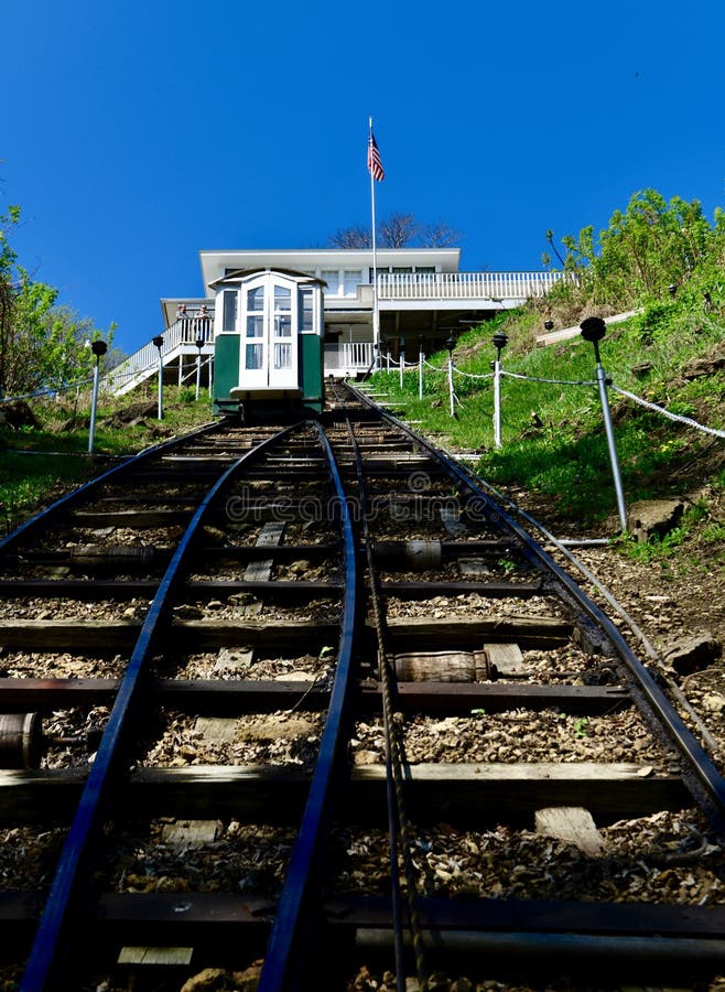 This is a Spring picture of a cable-car approaching the Fenelon Station, taken from a Cable-Car headed down to the Fourth Street Stztion, located in Dubuque, Iowa in Dubuque County. This is part of a two-stop, two-car, cable-car system known as the Fenelon Plave Elevator Compan that began operating in 1893. The cable-cars travel along 296 foot long tracks, at a 41 degree incline, to a 189 elevation change. This cable-car system was added to the National Register of Historic Places on August 3, 1978. This picture was taken on zmay 6, 2018. This is a Spring picture of a cable-car approaching the Fenelon Station, taken from a Cable-Car headed down to the Fourth Street Stztion, located in Dubuque, Iowa in Dubuque County. This is part of a two-stop, two-car, cable-car system known as the Fenelon Plave Elevator Compan that began operating in 1893. The cable-cars travel along 296 foot long tracks, at a 41 degree incline, to a 189 elevation change. This cable-car system was added to the National Register of Historic Places on August 3, 1978. This picture was taken on zmay 6, 2018.