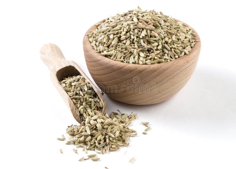 Fennel seeds in wooden bowl and scoop isolated on white background. Spices and food ingredients.
