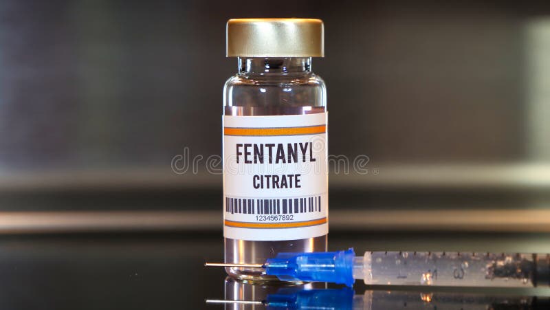 Fentanyl drug and syringe on black table