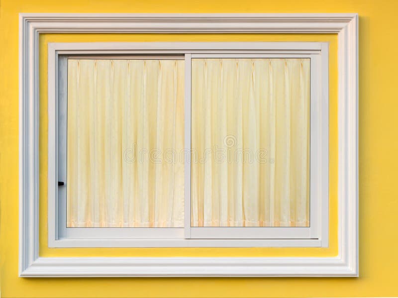 Close-up background A window of white concrete framing in a yellow wall with a beautiful soft brown curtain ine. Close-up background A window of white concrete framing in a yellow wall with a beautiful soft brown curtain ine.