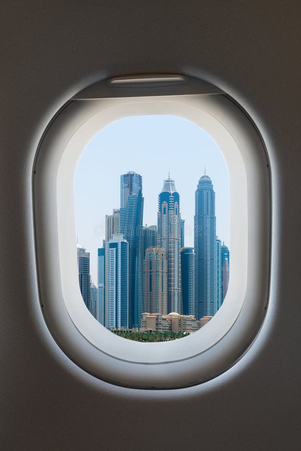 Airplane window from interior of aircraft with modern megalopolis city view. Airplane window from interior of aircraft with modern megalopolis city view.